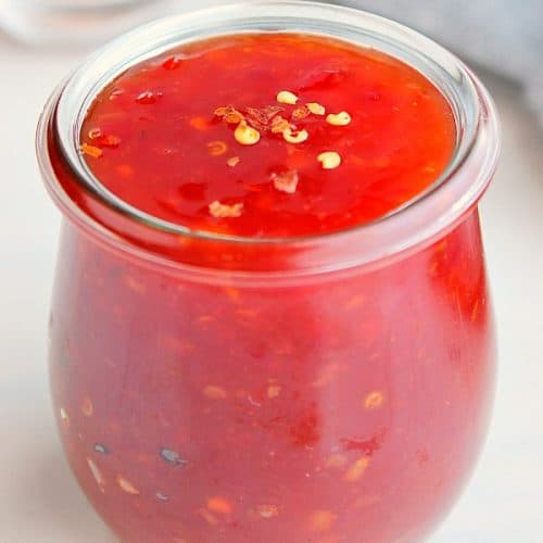Sweet and sour sauce in a glass jar.