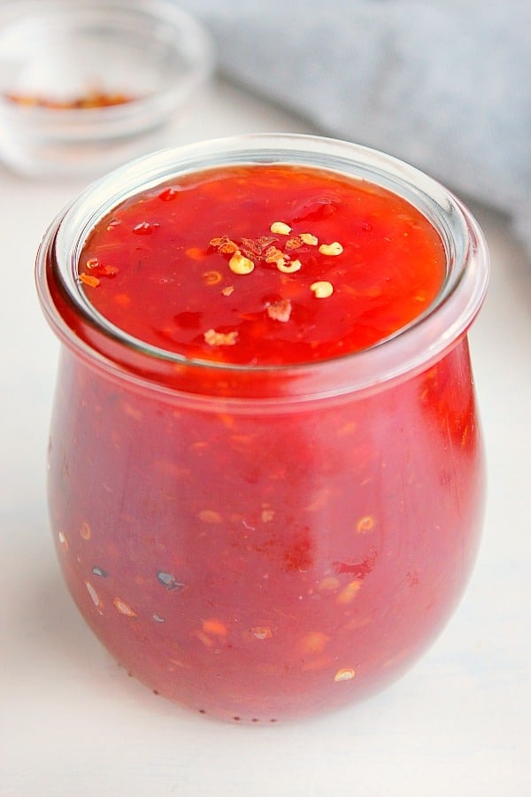 Sweet and sour sauce in a glass jar.