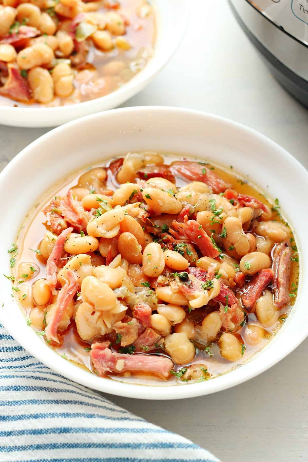 Instant Pot ham and bean soup in a white bowl.