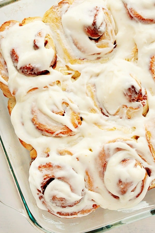 These Easy Cinnamon Rolls are soft, fluffy, have the best cinnamon filling and cream cheese frosting. Cinnamon rolls in a glass baking dish.