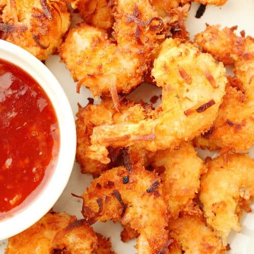 Coconut shrimp with sauce on a plate.