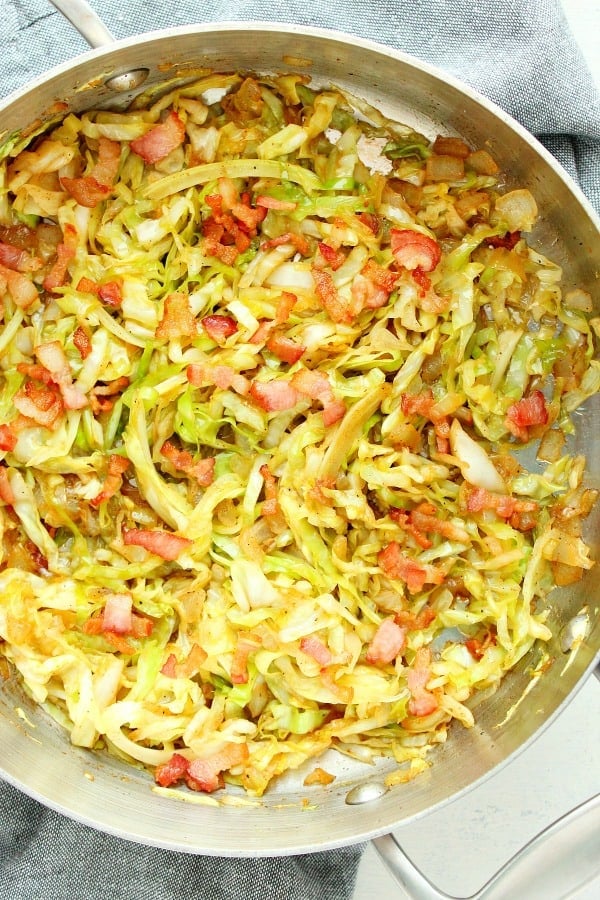 Fried Cabbage with bacon in a pan.