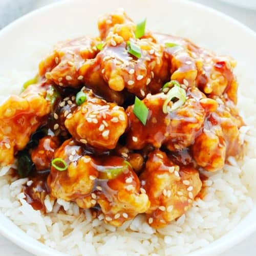 General Tso's chicken on rice on a plate.