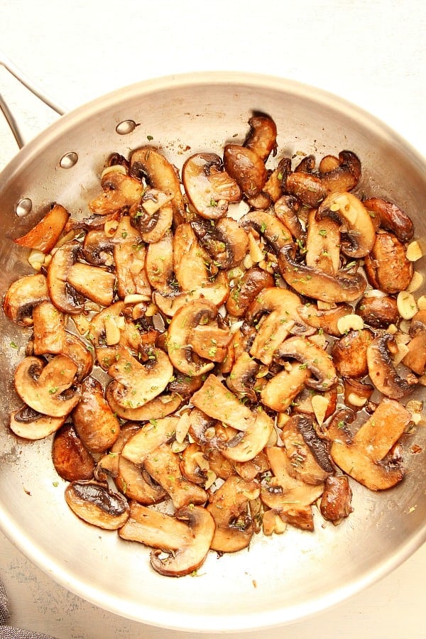 These Sauteed Mushrooms in garlic butter will take any dish to a new level! It only takes 10 minutes to make them. Sauteed Mushrooms in a pan.