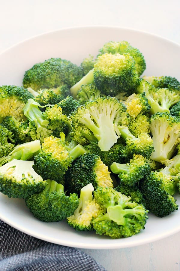 Steamed broccoli in a white bowl.