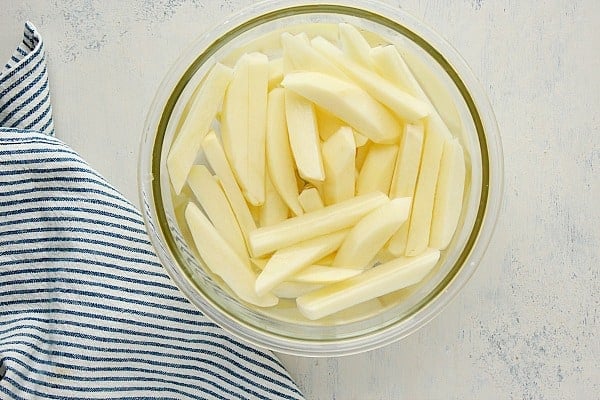 Fries in water in a bowl.