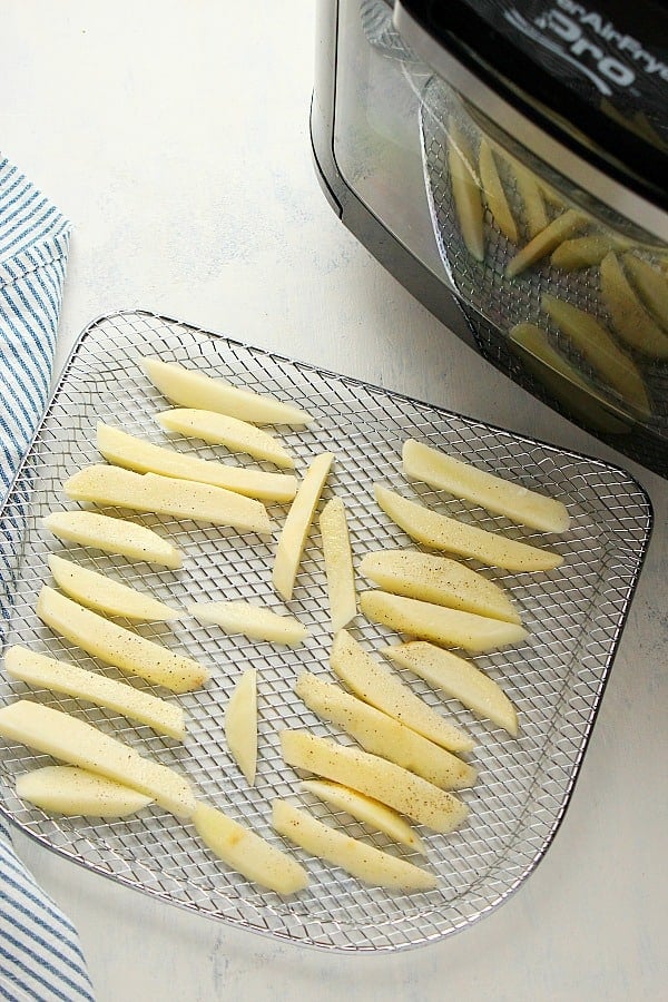 French fries on a air fryer rack.