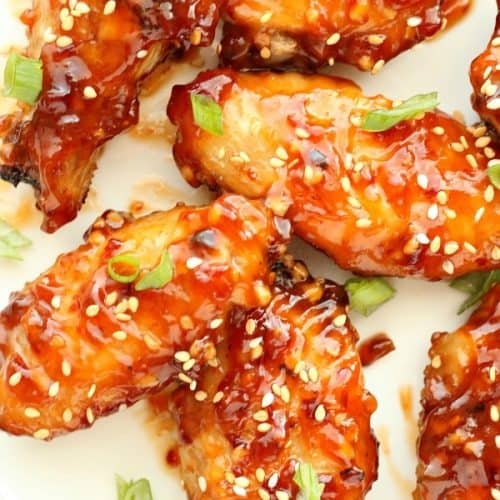Asian chicken wings on a white plate.