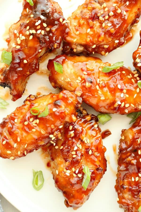 Asian chicken wings on a white plate.