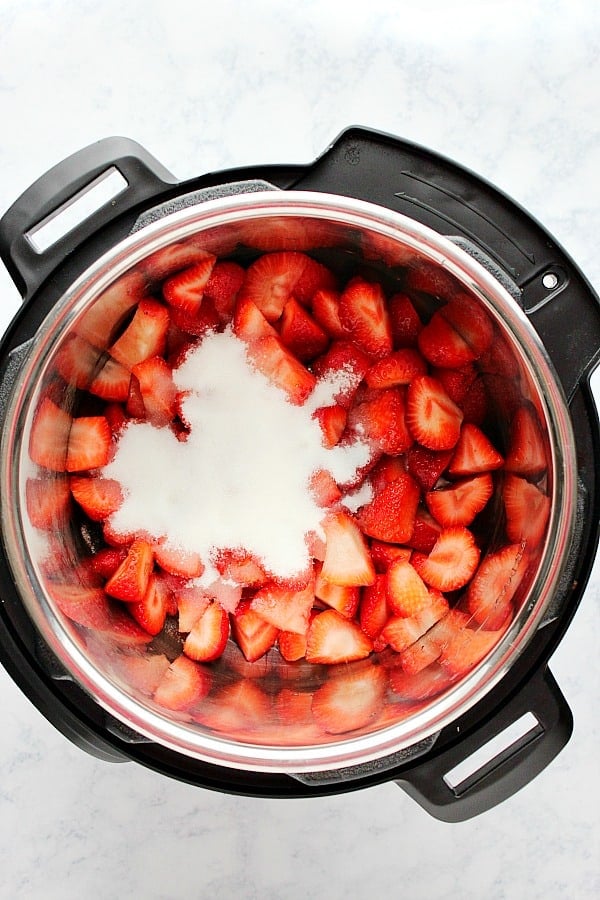 Chopped strawberries with sugar in pressure cooker.