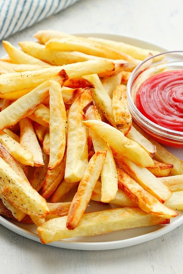 Air Fryer French Fries are a delicious and healthy version of a popular fast food side dish. Air fryer French fries on a plate.