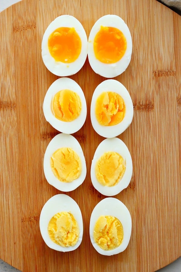 Sliced cooked eggs on a cutting board.