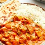Butter chicken with rice and flatbread.