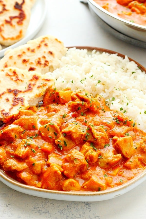 Butter chicken with rice and flatbread.