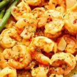 Garlic butter shrimp on a plate with asparagus.