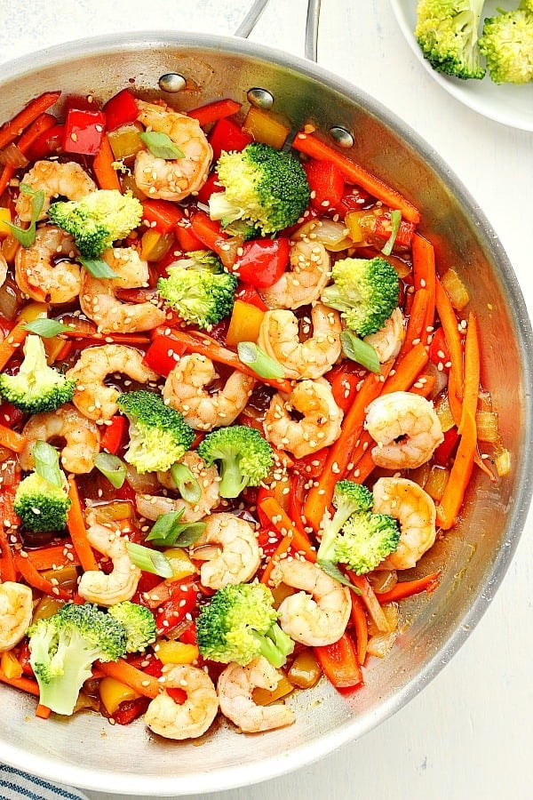 This easy Shrimp Stir Fry recipe is made with fresh shrimp, veggie mix and stir fry sauce, all done in 15 minutes. Shrimp Stir Fry in a skillet.