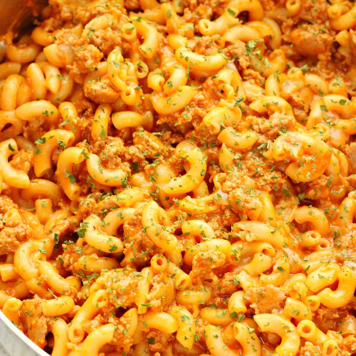 Hamburger and macaroni in a skillet.