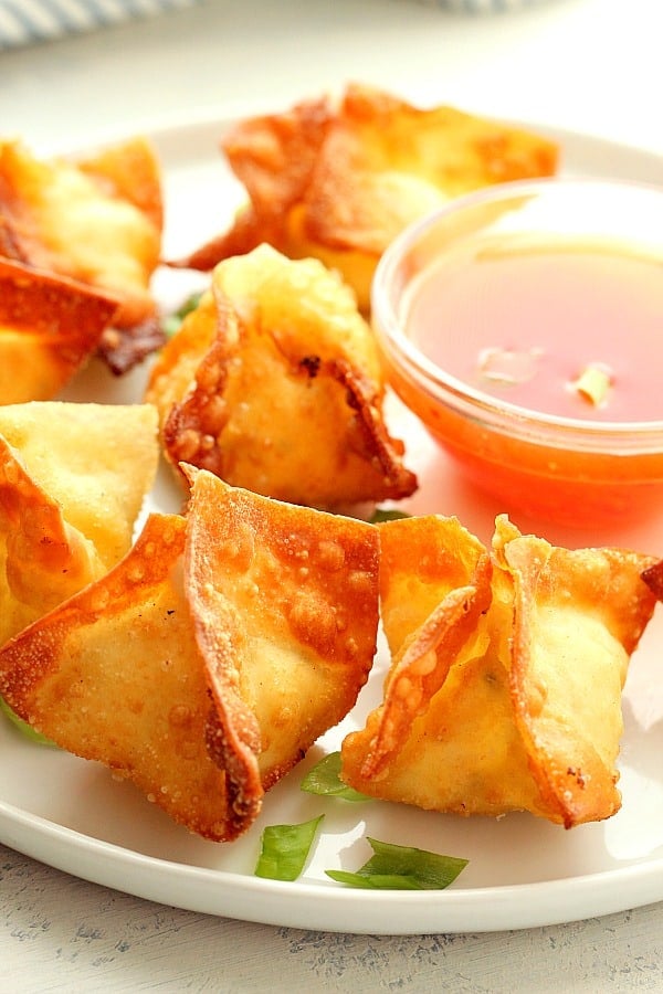 Cream Cheese Wontons recipe Wontons with sauce on a plate.