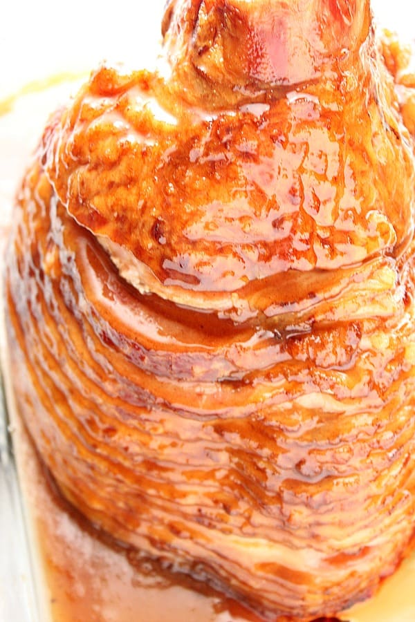 Glazed ham in a baking dish.