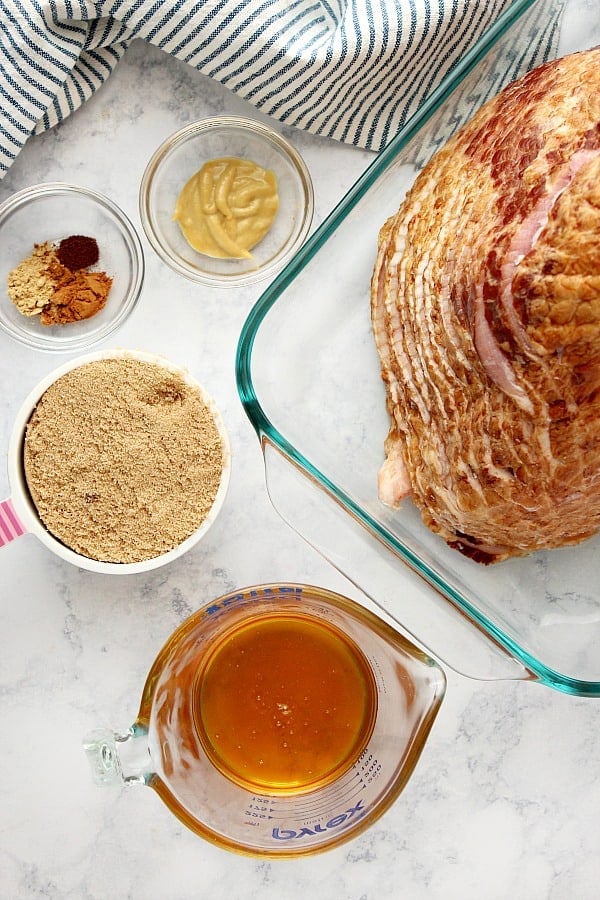 Ingredients for baked ham on a marble board.