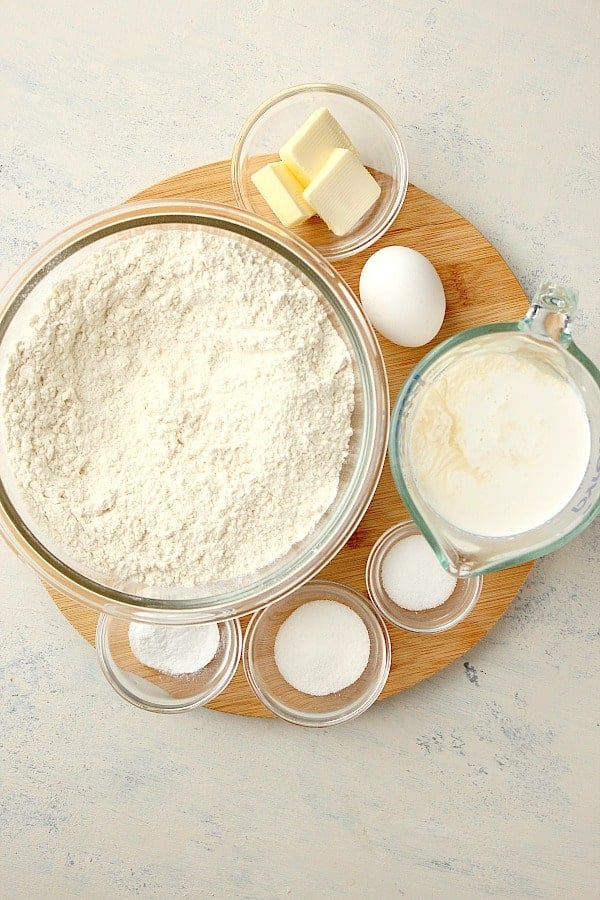 Ingredients for bread on a round cutting board.