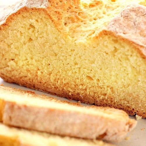 Bread with slices on a cutting board.