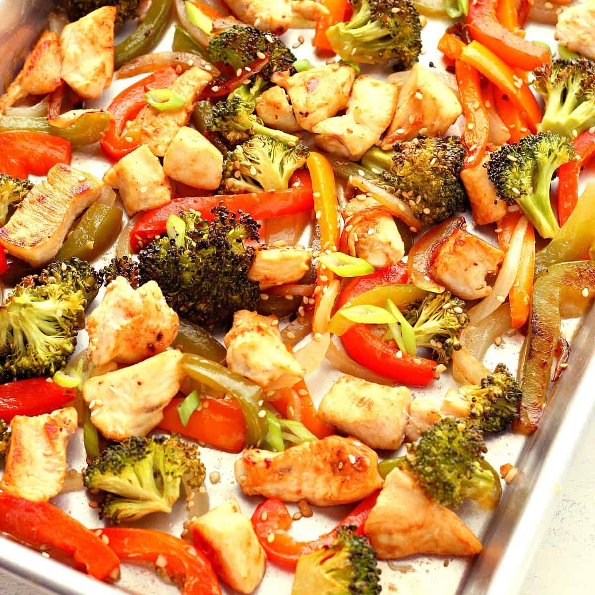 Veggies and chicken on a sheet pan.