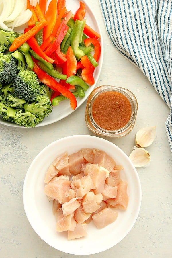 Ingredients for stir fry on a white board.