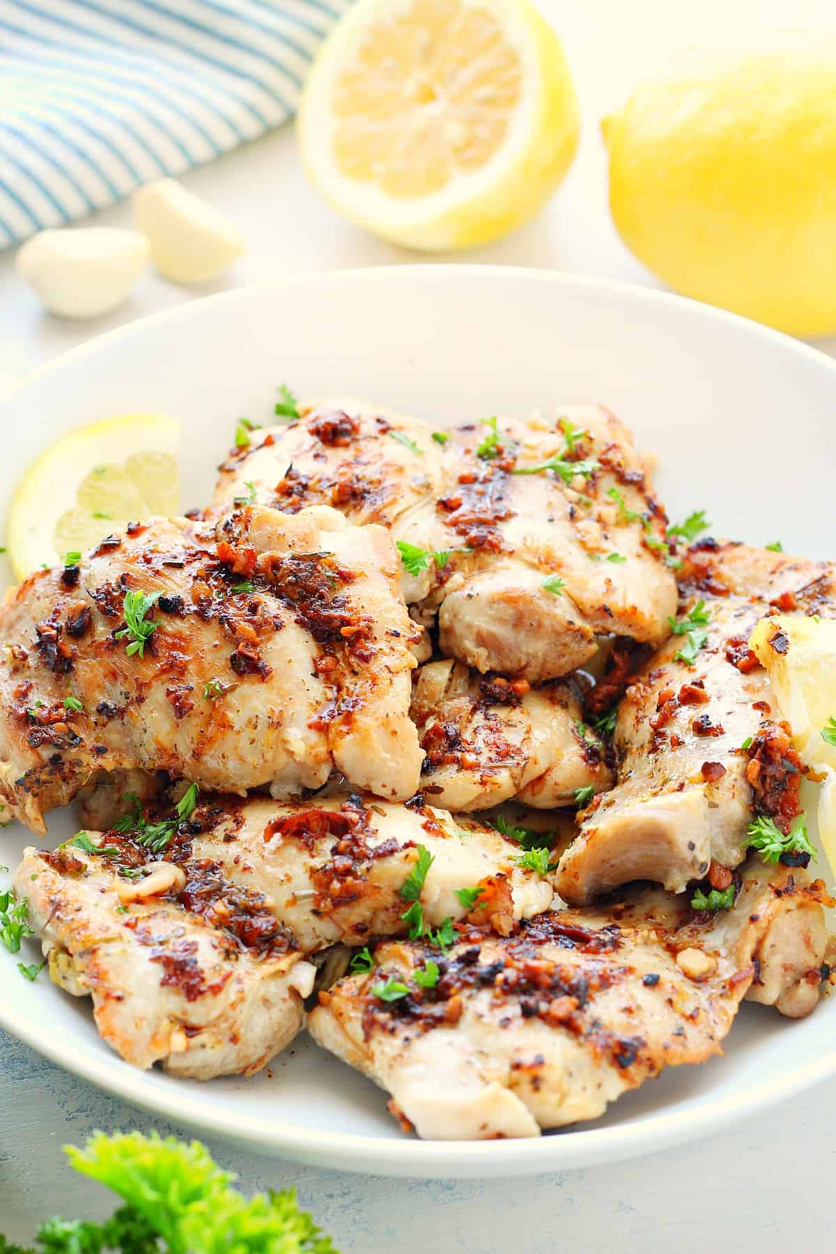 Chicken thighs in a white bowl.