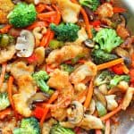 Chicken and veggies in a skillet.