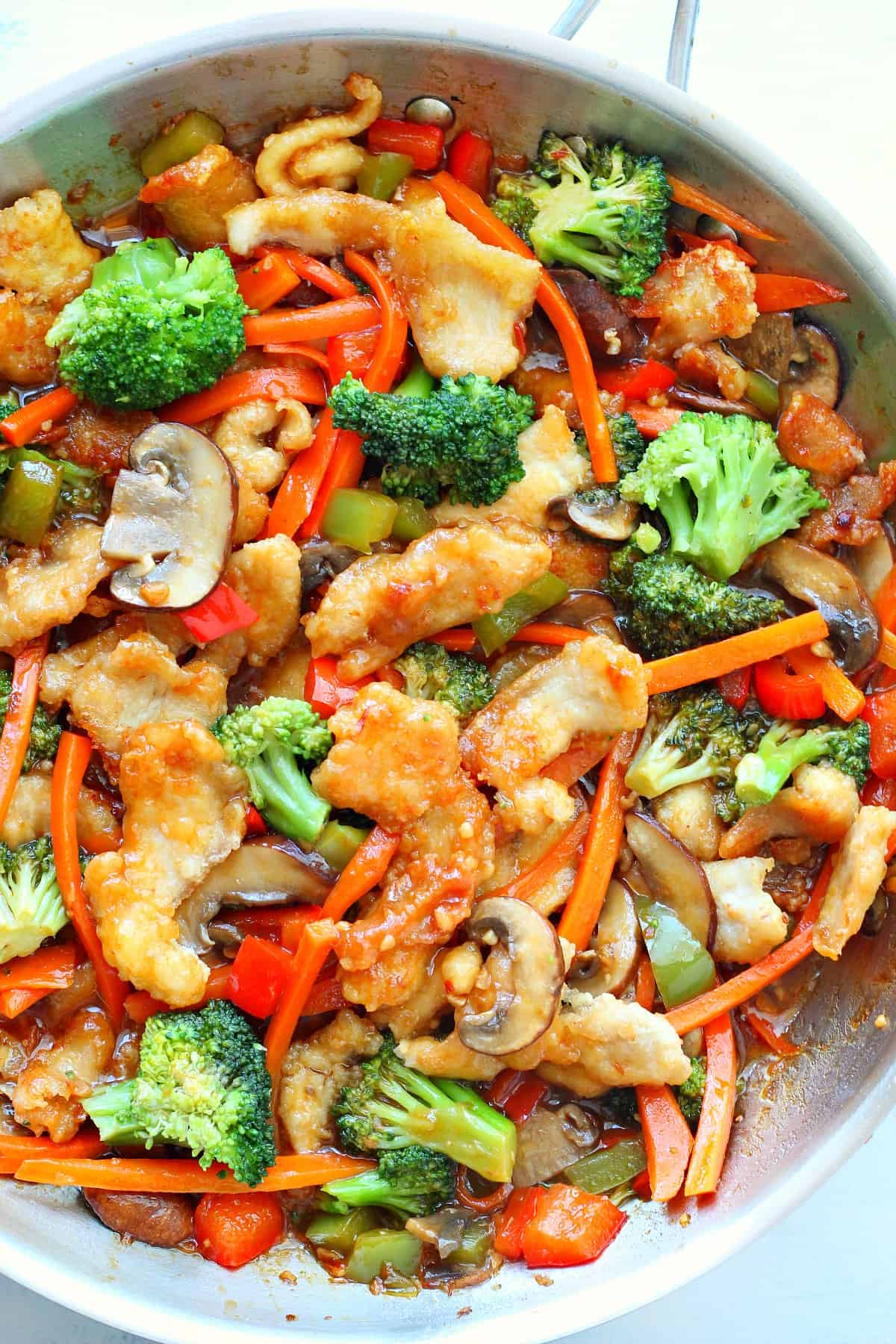 Chicken and veggies in a skillet.