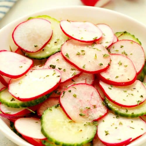Sliced radishes and cucumber in a bowl.