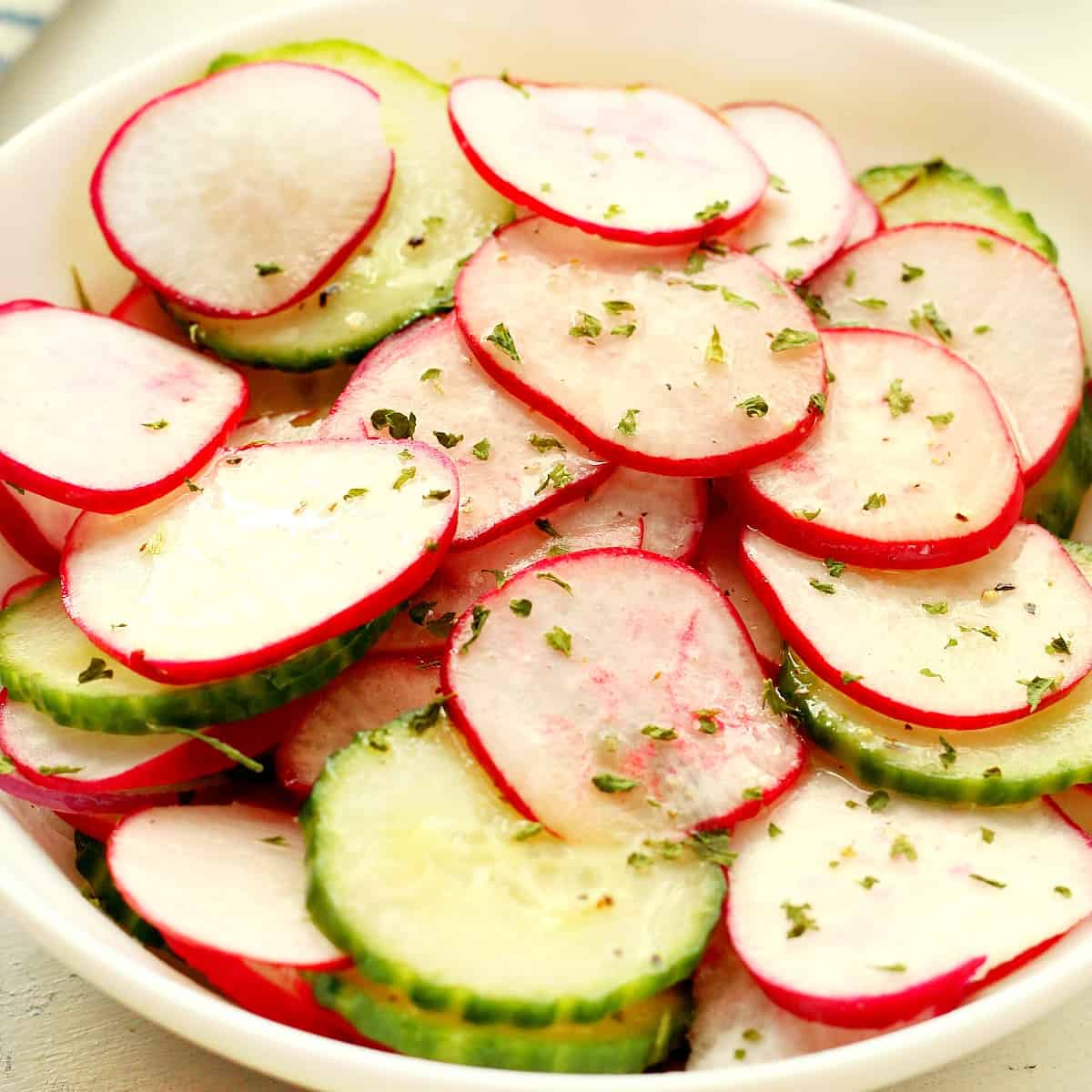 Radish and cucumber in a bowl.