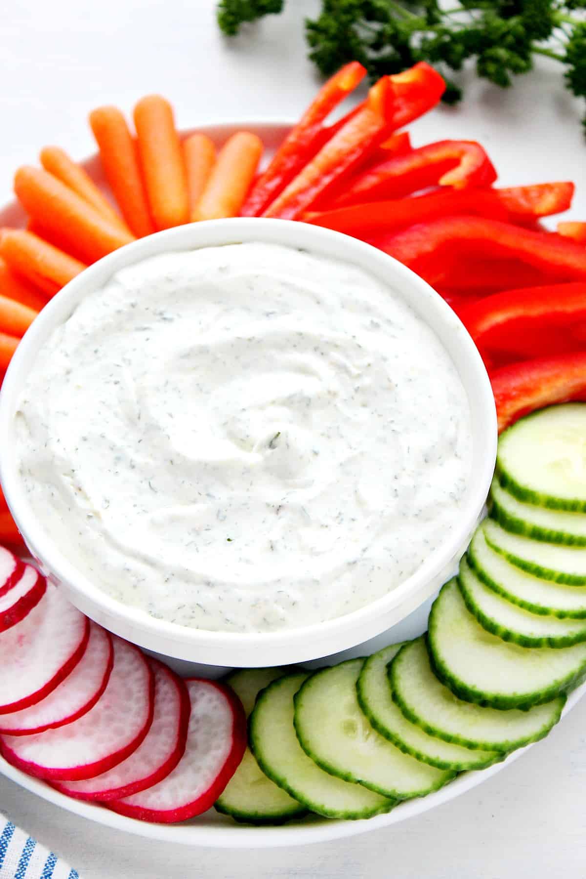 Dip in a bowl with veggies on plate.