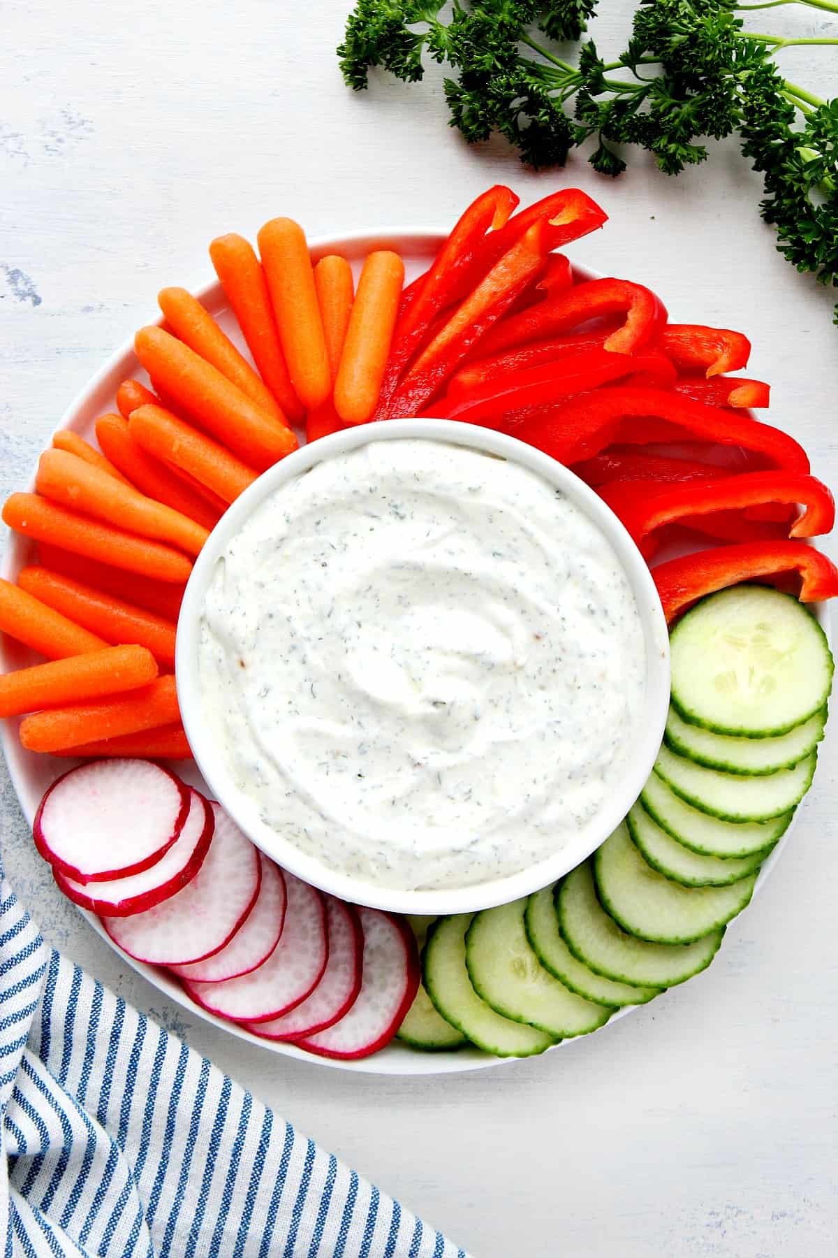 Dip with cut veggies on a plate.