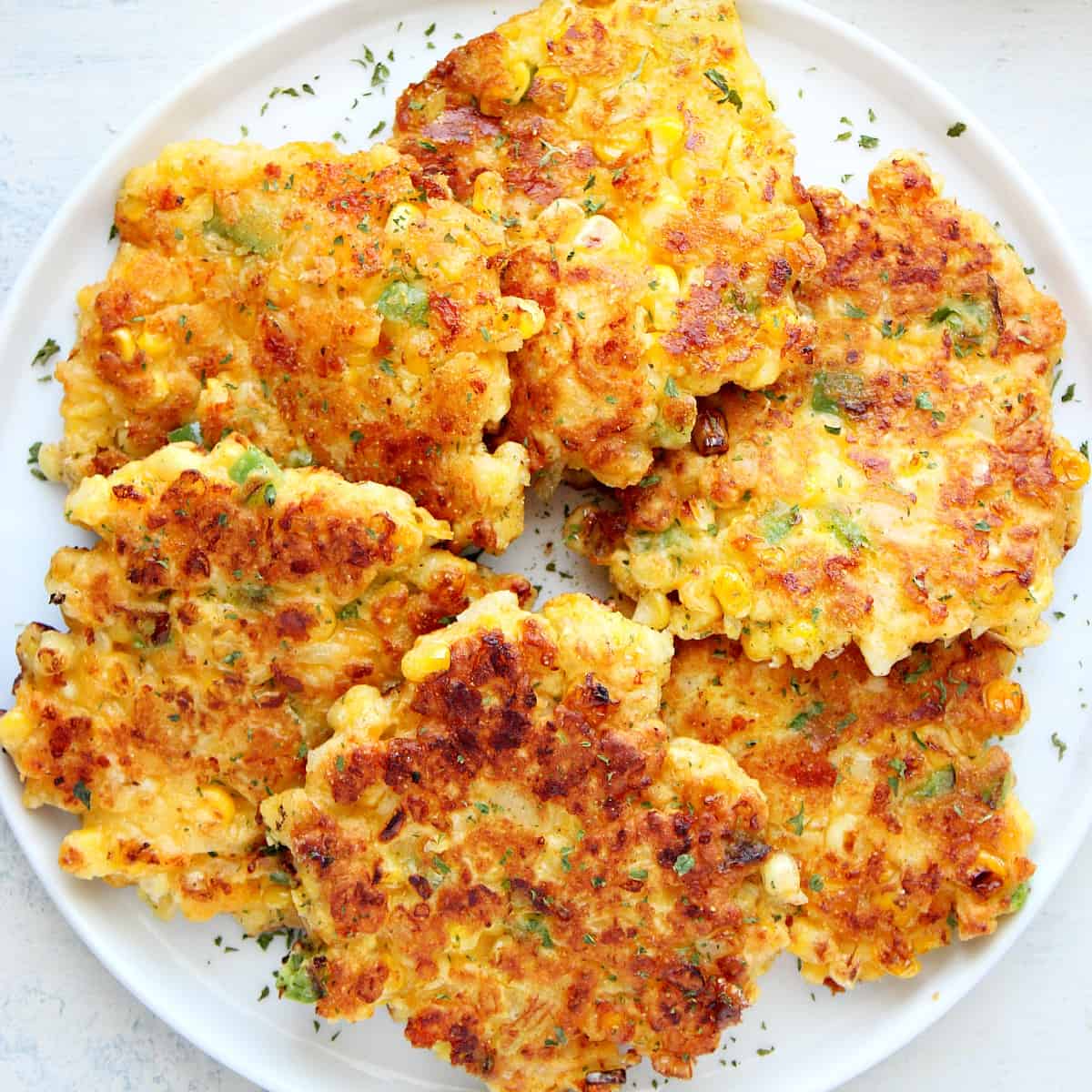 Fried corn cakes on plate.