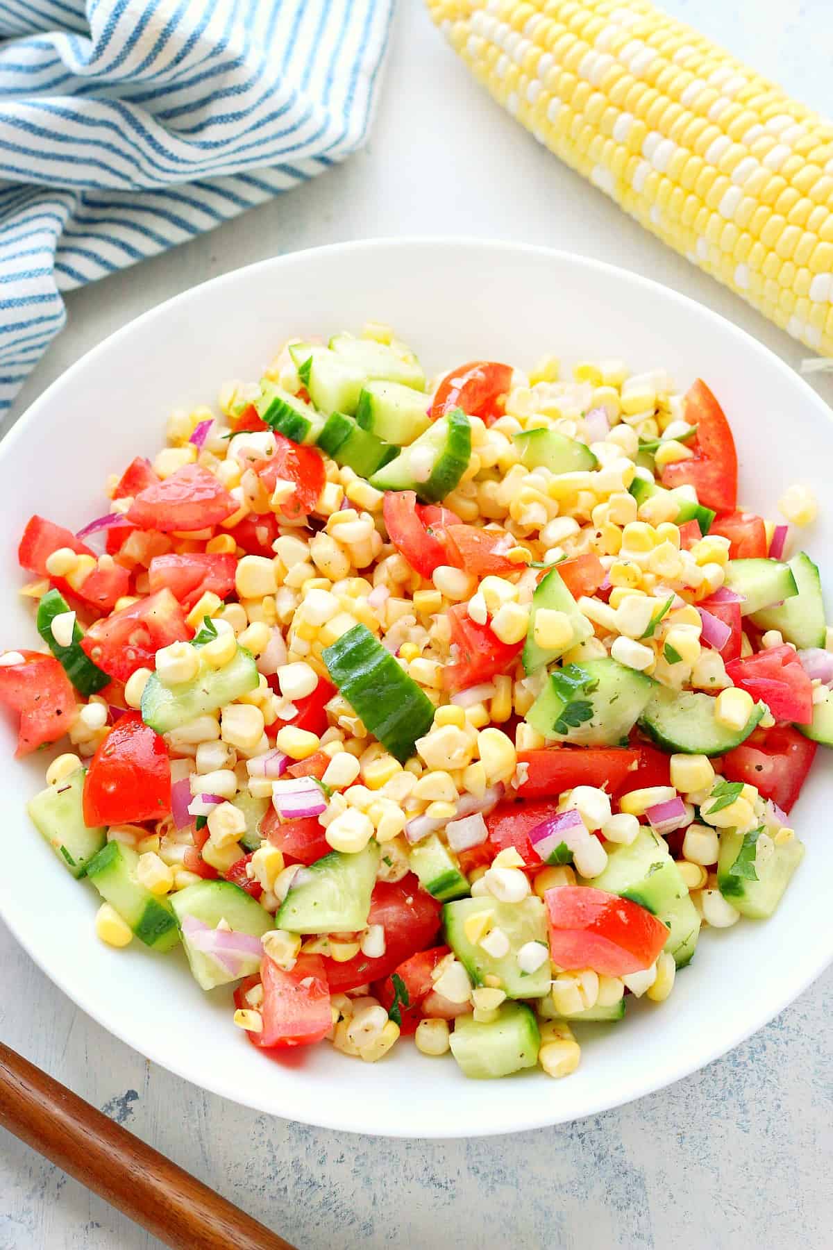 Corn salad in a white serving bowl.