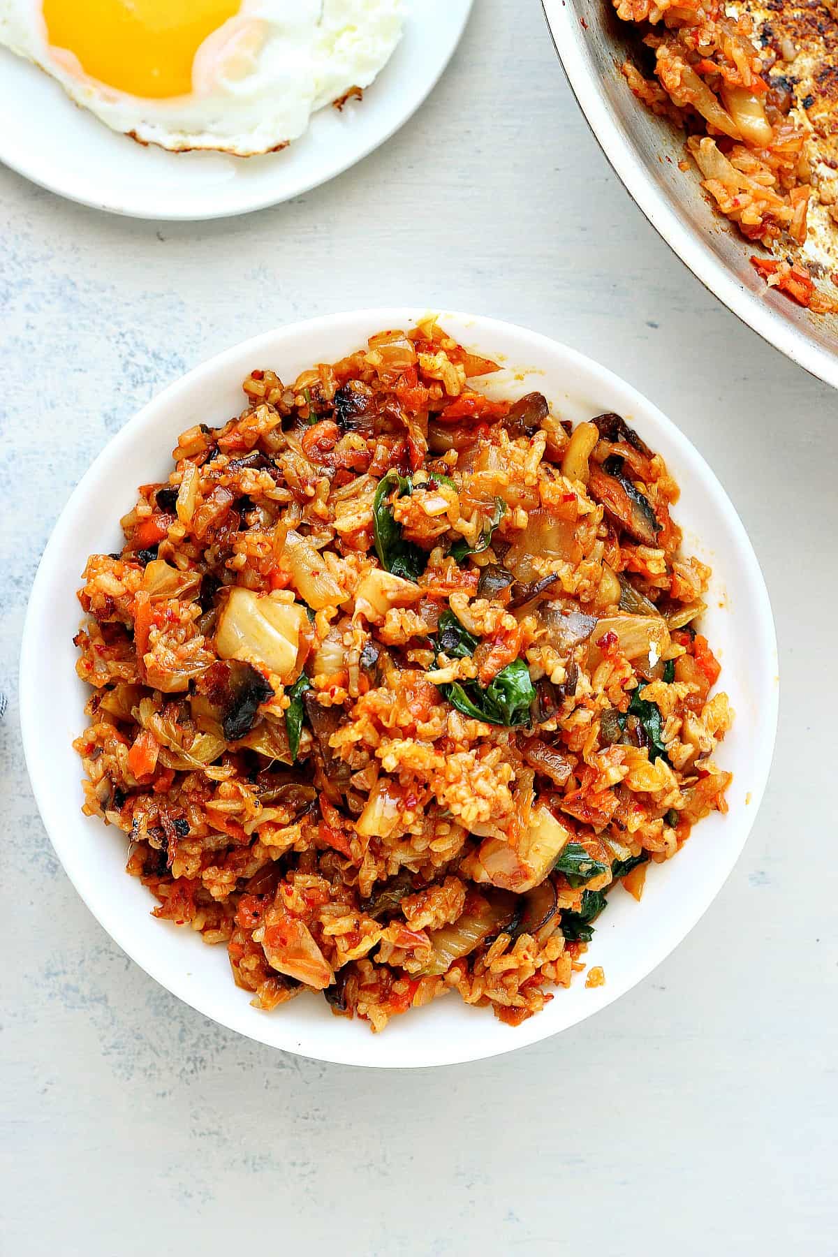 Rice with kimchi in a white bowl.