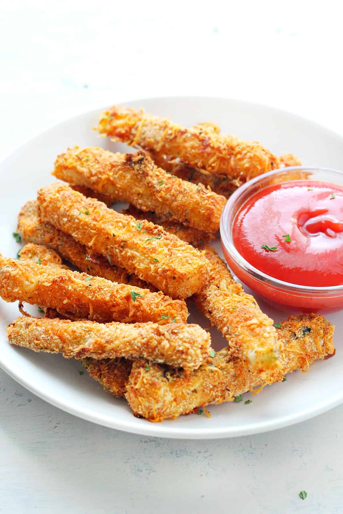 Zucchini fries on white plate.