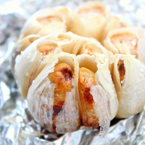 Roasted garlic bulb on a foil.