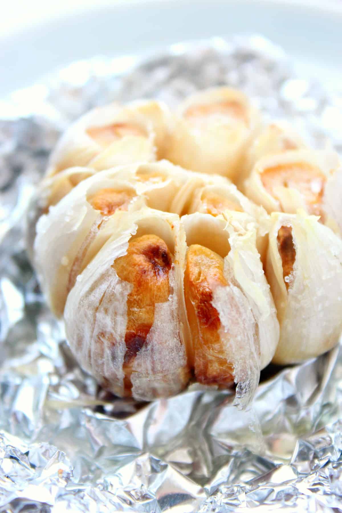Air Fryer Roasted Garlic recipe Roasted garlic bulb on a foil.