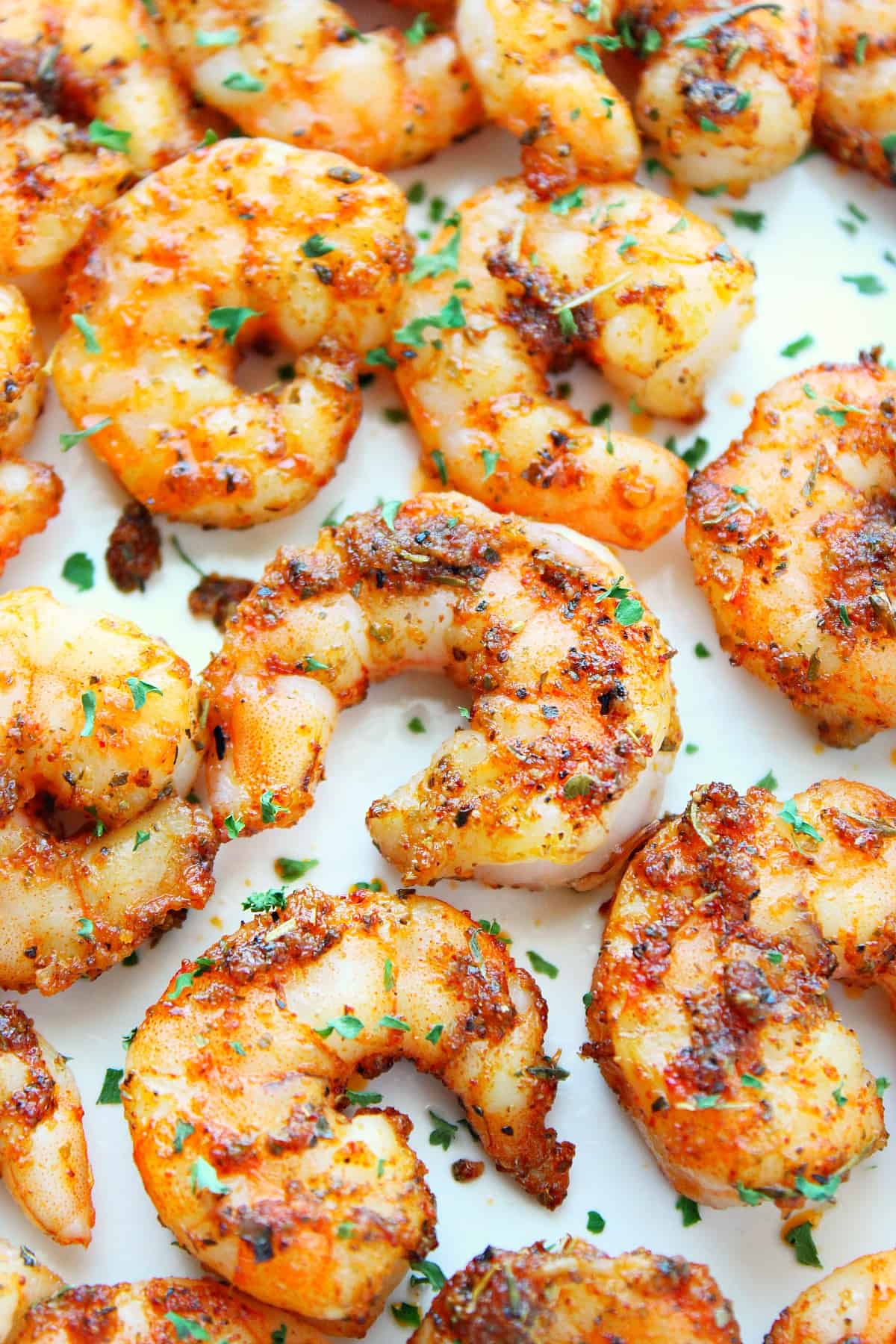 Cooked shrimp on white plate.