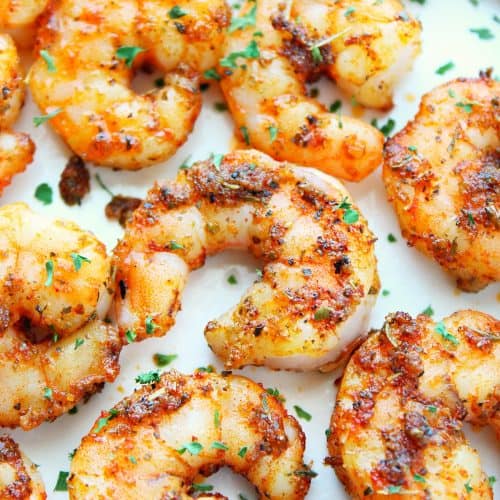 Cooked shrimp on a white plate.