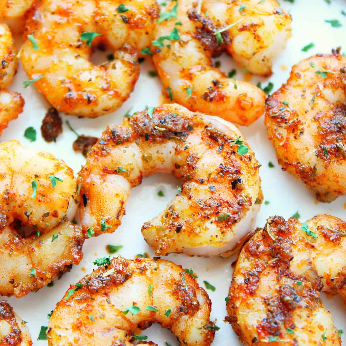 Cooked shrimp on a white plate.