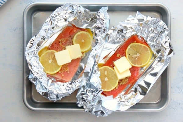 Salmon packets on a baking sheet.