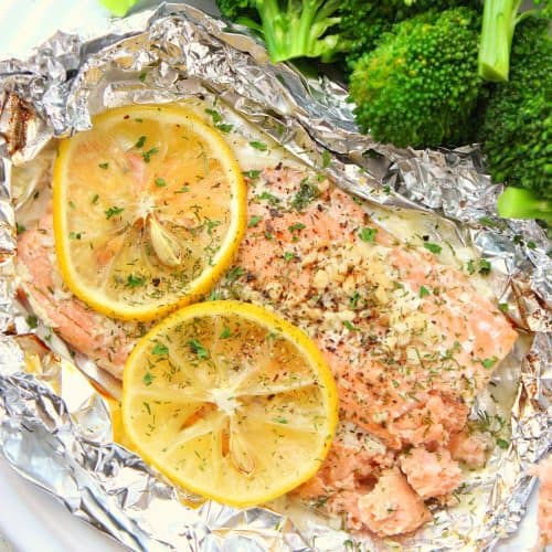 Salmon on a foil on a plate.