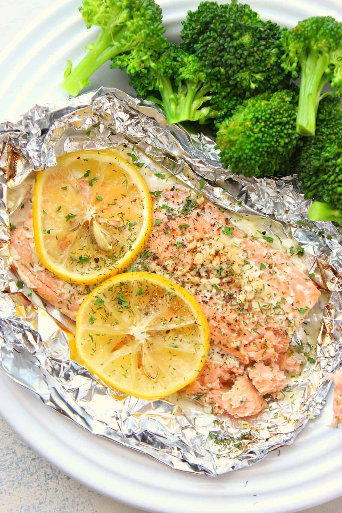 Salmon on a foil on a plate.