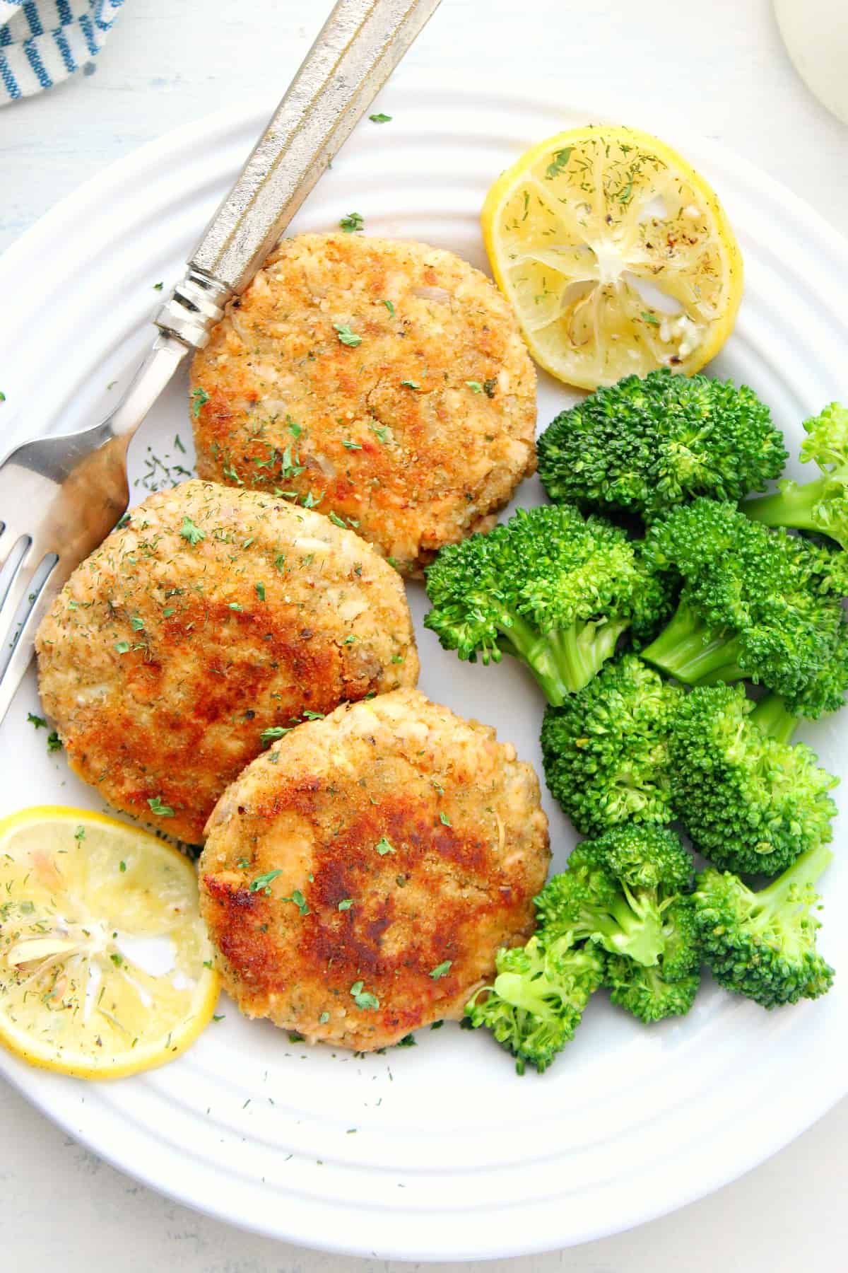 Salmon cakes on a white plate.