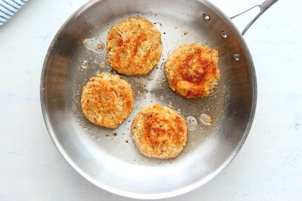 Salmon cakes in a pan.