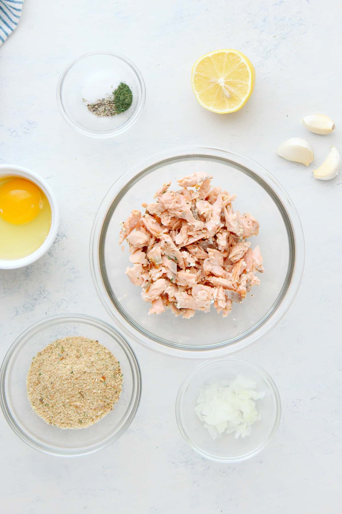 Ingredients for salmon patties on a board.